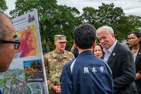 Group of people surrounding a poster board