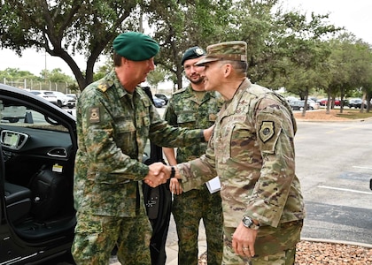 U.S. Air Force Lt. Gen. Thomas Hensley, commander, 16th Air Force (Air Forces Cyber), and Maj. Gen. Van Den Berg, commander of the Netherlands Defence Cyber Command shake hands in greeting.
