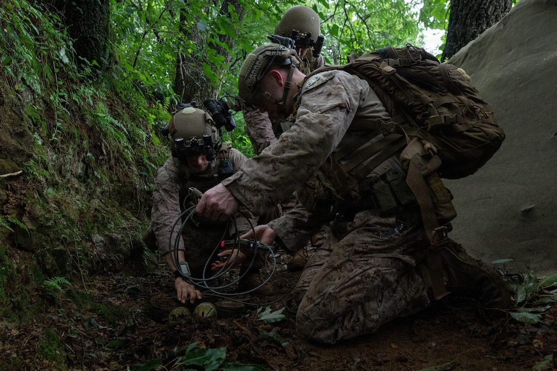 U.S. Marine Corps Staff Sgt. Jake Arcidiacano, left, and Sgt. Angus Wright, explosive ordnance disposal technicians with Charlie Section, 3rd Explosive Ordnance Disposal Company, 9th Engineer Support Battalion, 3rd Marine Logistics Group, prepare an explosive charge for ordnance disposal during Korean Marine Exchange Program 26.2 on LPP Gold Mine Training Area, South Korea, July 20, 2026. KMEP 26.2 is a semiannual bilateral exercise designed to improve combined readiness, strengthen the Republic of Korea-U.S. alliance and promote stability in the Indo-Pacific region. (U.S. Marine Corps photo by Cpl. Pedro Rojas)