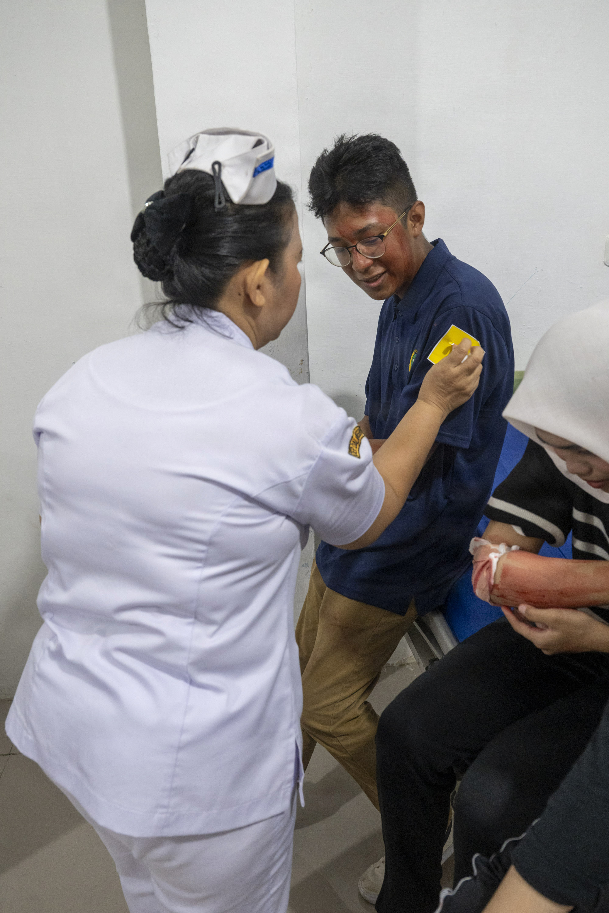 U.S. Army Reserve Specialist Marvin Martinez, center, civil affairs specialist assigned to Pacific Partnership 2026 (PP26), acts as a simulated casualty during a two-day PP26 humanitarian assistance and disaster preparedness field training exercise at Rumah Sakit FL Tobing Sibolga hospital in Sibolga, Indonesia, July 28, 2026
