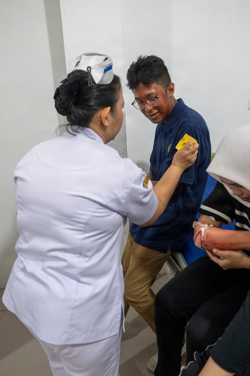 U.S. Army Reserve Specialist Marvin Martinez, center, civil affairs specialist assigned to Pacific Partnership 2026 (PP26), acts as a simulated casualty during a two-day PP26 humanitarian assistance and disaster preparedness field training exercise at Rumah Sakit FL Tobing Sibolga hospital in Sibolga, Indonesia, July 28, 2026