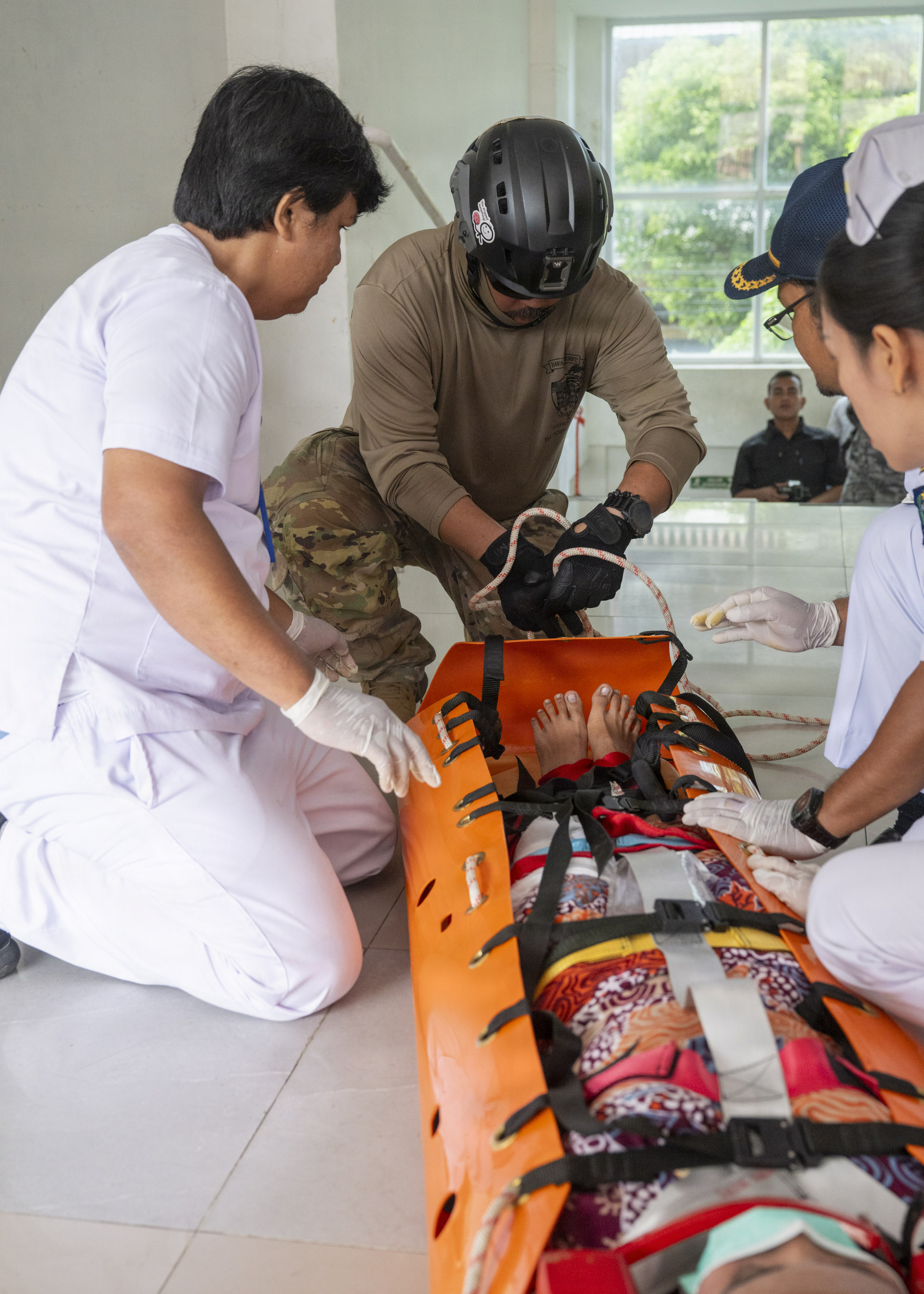 U.S. Army Hawaii National Guard Sgt. 1st Class Ross Nakatsu, combat engineer assigned to Pacific Partnership 2026 (PP26), assists Indonesian doctors in securing a simulated casualty during a two-day PP26 humanitarian assistance and disaster preparedness field training exercise at Rumah Sakit FL Tobing Sibolga hospital in Sibolga, Indonesia, July 28, 2026