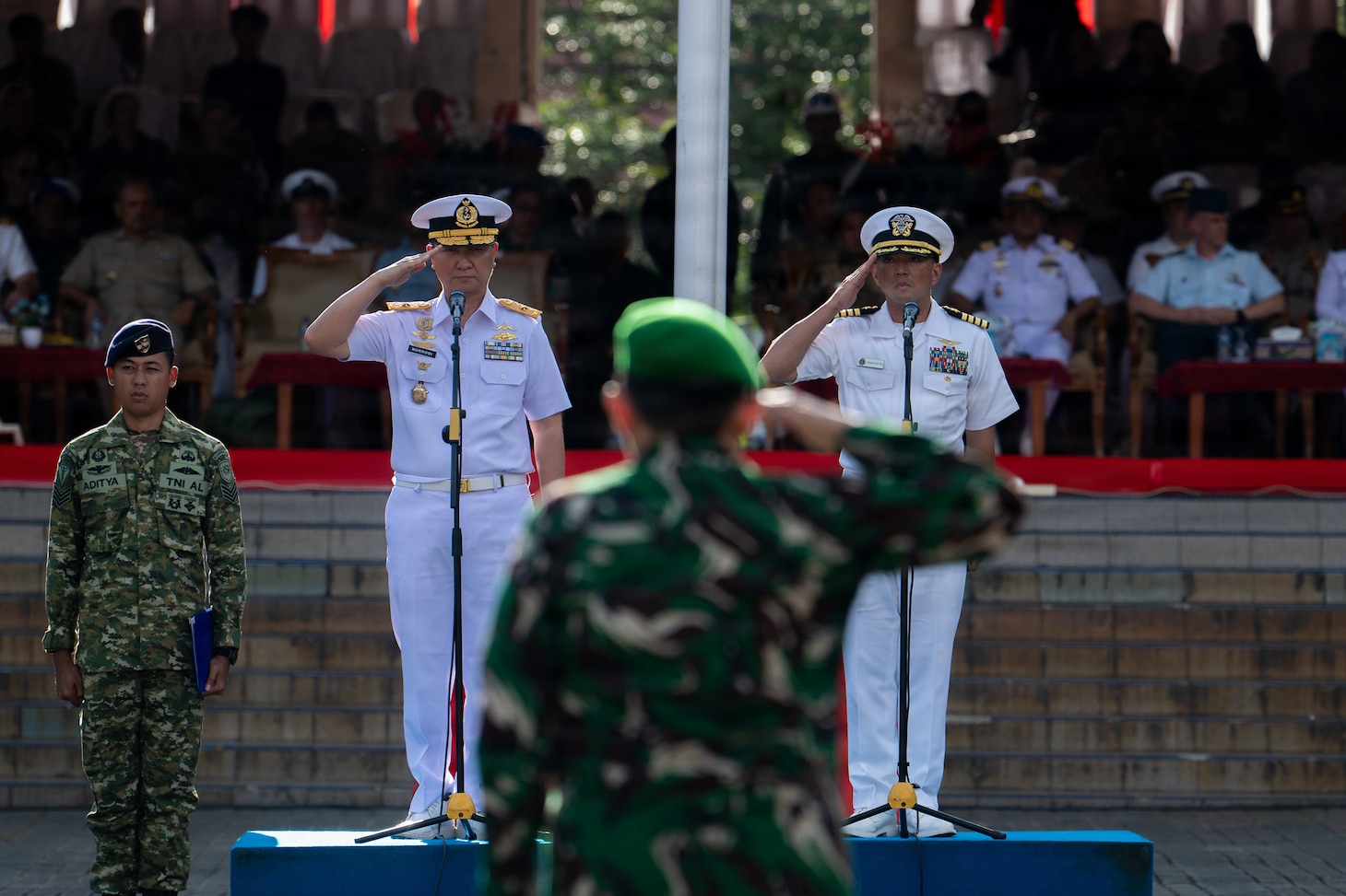 U.S. Navy Capt. Robert Reyes, right, mission commander of Pacific Partnership 2026 (PP26), and Indonesian National Armed Forces (Tentara Nasional Indonesia) First Adm. Tjahja Nurrobi, left, TNI deputy surgeon general, render a salute during the PP26 Indonesia mission stop closing ceremony at Simare-Mare Field in Sibolga, Indonesia, July 30, 2026