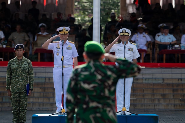 U.S. Navy Capt. Robert Reyes, right, mission commander of Pacific Partnership 2026 (PP26), and Indonesian National Armed Forces (Tentara Nasional Indonesia) First Adm. Tjahja Nurrobi, left, TNI deputy surgeon general, render a salute during the PP26 Indonesia mission stop closing ceremony at Simare-Mare Field in Sibolga, Indonesia, July 30, 2026