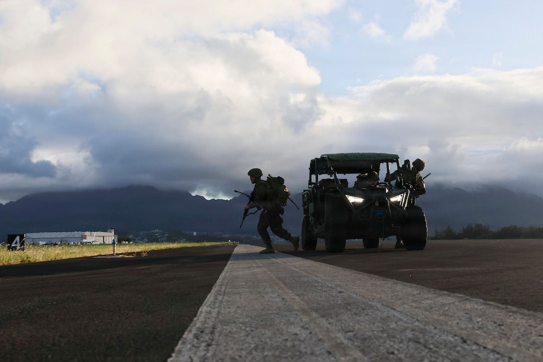 U.S. Marines with Marine Air Control Squadron 4, Marine Air Control Group 18, 1st Marine Aircraft Wing, dismount from an ultra-light tactical vehicle to establish a simulated expeditionary airfield landing zone at Marine Corps Air Station Kaneohe Bay, Hawaii, Aug. 10, 2026.