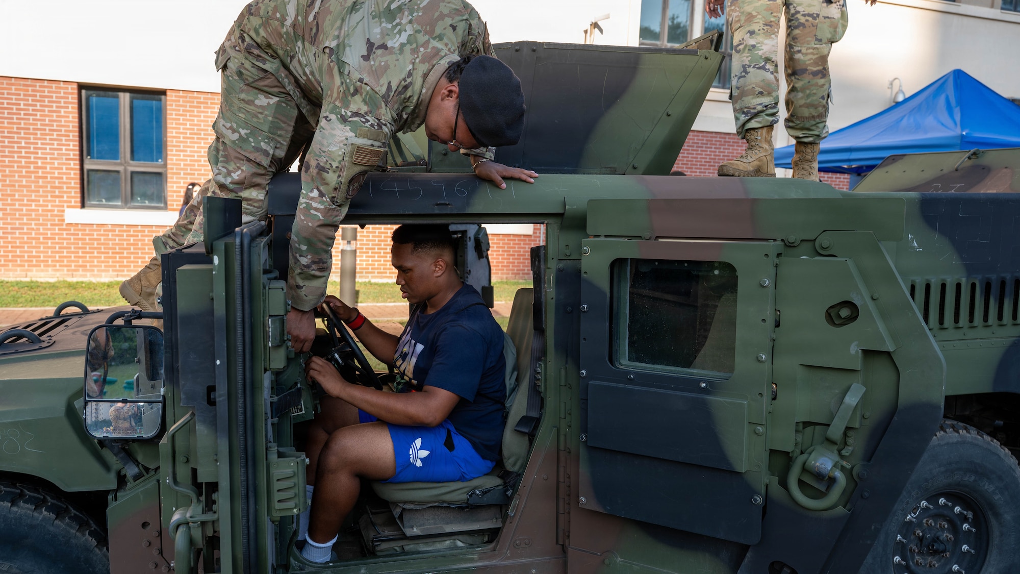 U.S. Airmen demonstrate military equipment to children during the “Back to School, Ready, Set, Grow” event at Osan Air Base, Republic of Korea, Aug. 11, 2026. Connecting military children with Airmen and the mission helps strengthen the sense of community at Osan and reflects the installation’s commitment to taking care of Airmen and their families. (U.S. Air Force photo by Senior Airman Megan Cusmano)