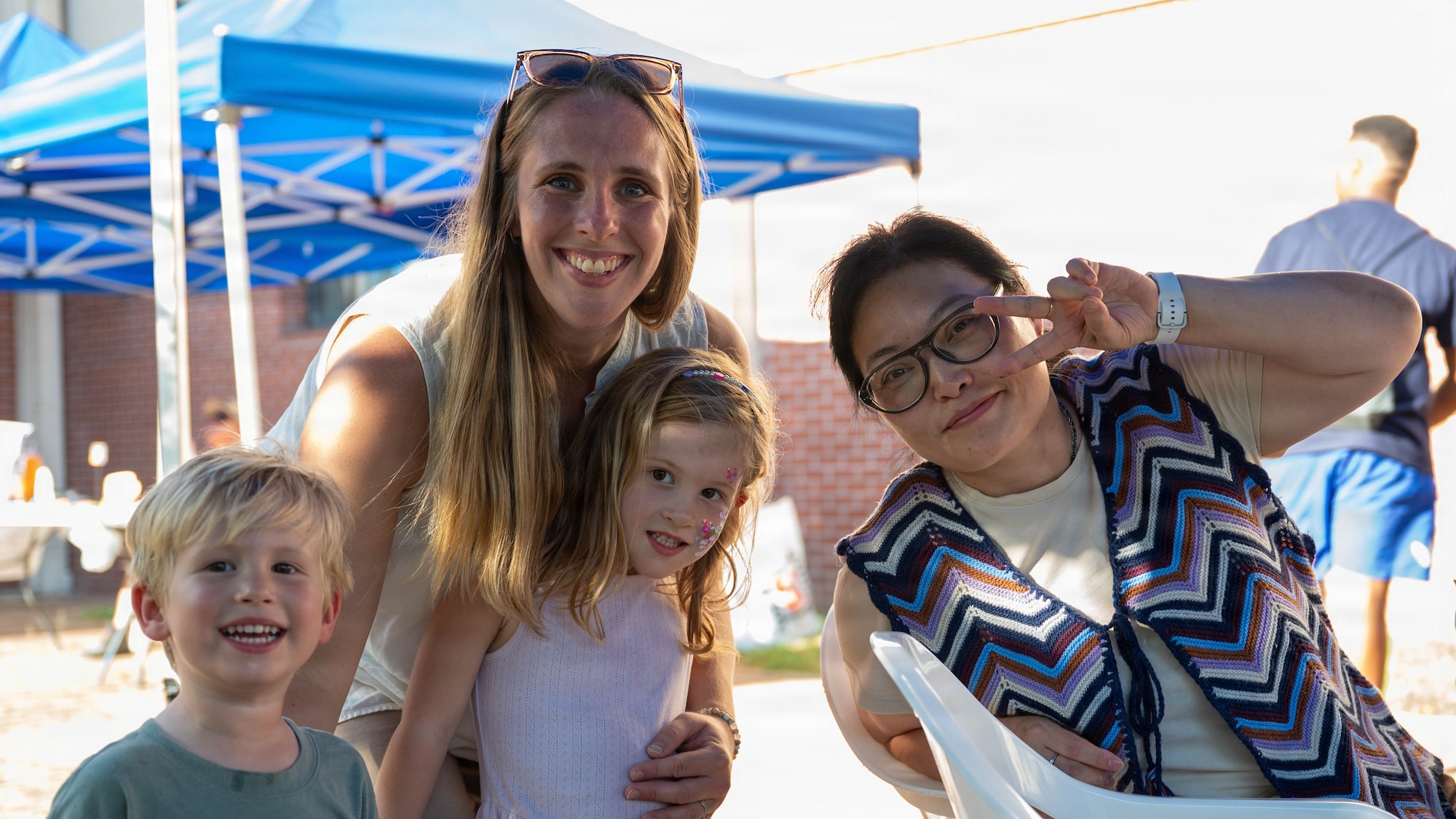 Military family members pose for a photo during the “Back to School, Ready, Set, Grow” event at Osan Air Base, Republic of Korea, Aug. 11, 2026. As Osan implements tour normalization, events and programs that connect families with one another provide Airmen and their families opportunities to build a strong support network throughout their time in Korea. (U.S. Air Force photo by Senior Airman Megan Cusmano)