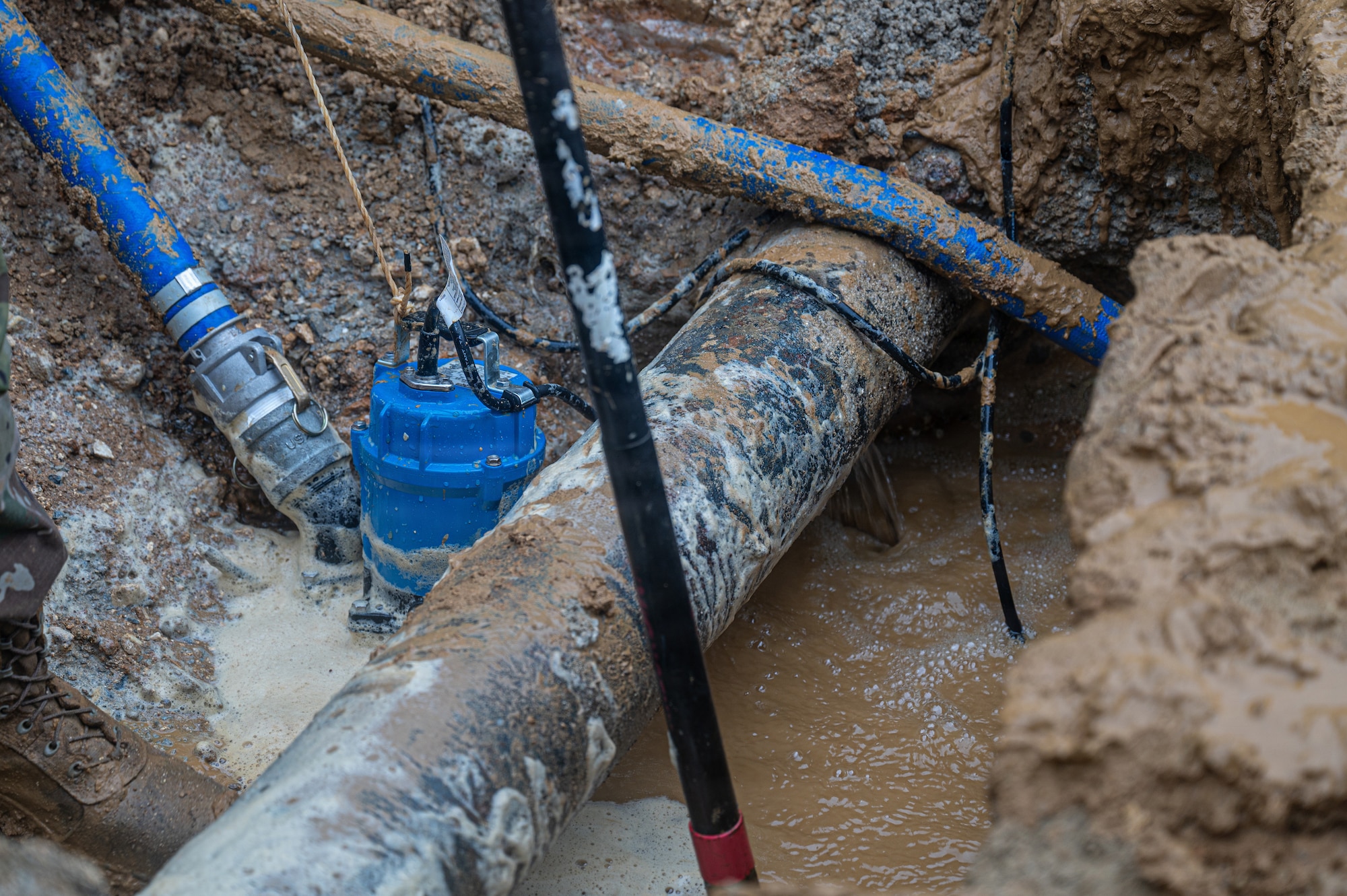 Water flows from a ruptured water pipe.