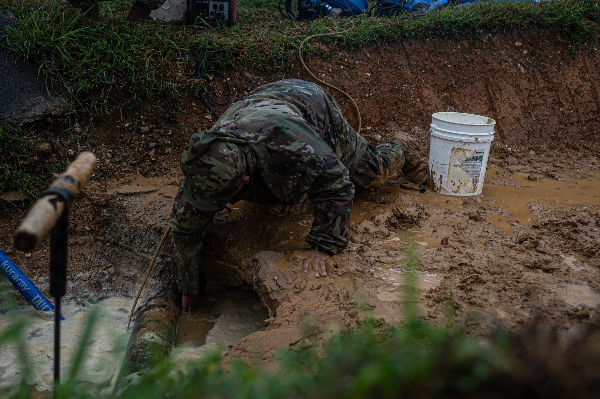 Airman assesses an area for leaks before conducting repairs.