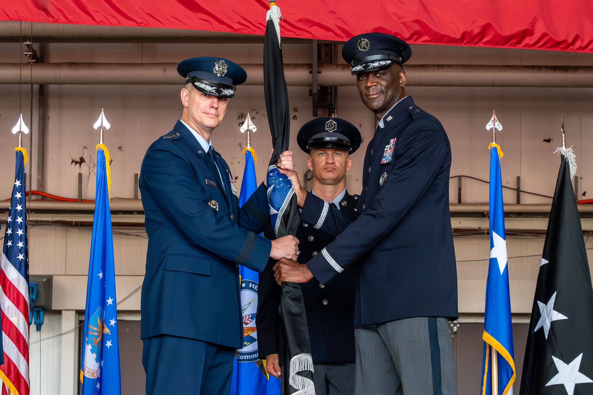 U.S. Space Force Brig. Gen. Jacob Middleton, U.S. Space Forces Europe – Space Forces Africa outgoing commander, passes the guide-on to relinquish command to U.S. Air Force Gen. Alexus G. Grynkewich, commander, U.S. European Command and NATO Supreme Allied Commander Europe