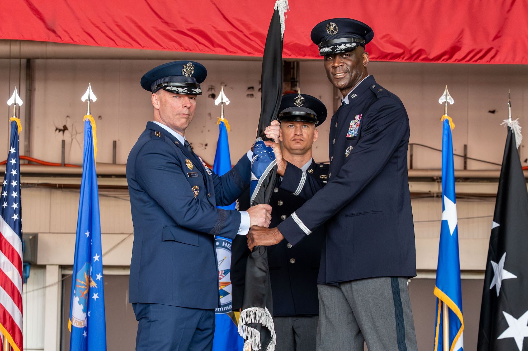 U.S. Space Force Brig. Gen. Jacob Middleton, U.S. Space Forces Europe – Space Forces Africa outgoing commander, passes the guide-on to relinquish command to U.S. Air Force Gen. Dagvin R.M. Anderson, commander, U.S. Africa Command