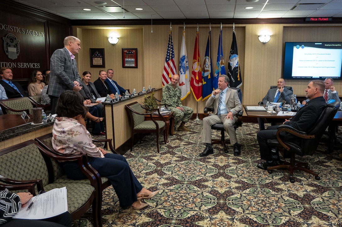 Defense Logistics Agency Vice Director Brad Bunn (seated at center) talks with DLA Disposition Services staff at the Hart-Dole-Inouye Federal Center in Battle Creek, Michigan on August 11, 2026.