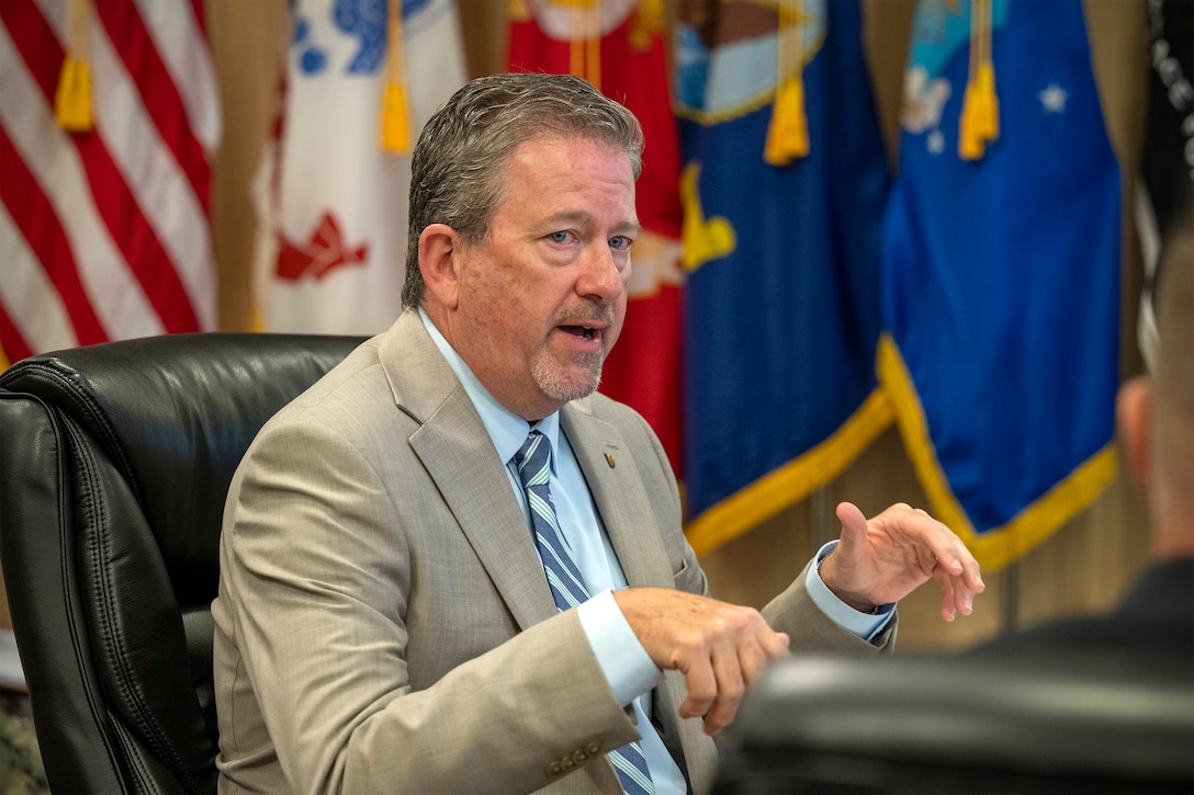 Defense Logistics Agency Vice Director Brad Bunn talks with DLA Disposition Services leaders at the Hart-Dole-Inouye Federal Center in Battle Creek, Michigan on August 11, 2026.