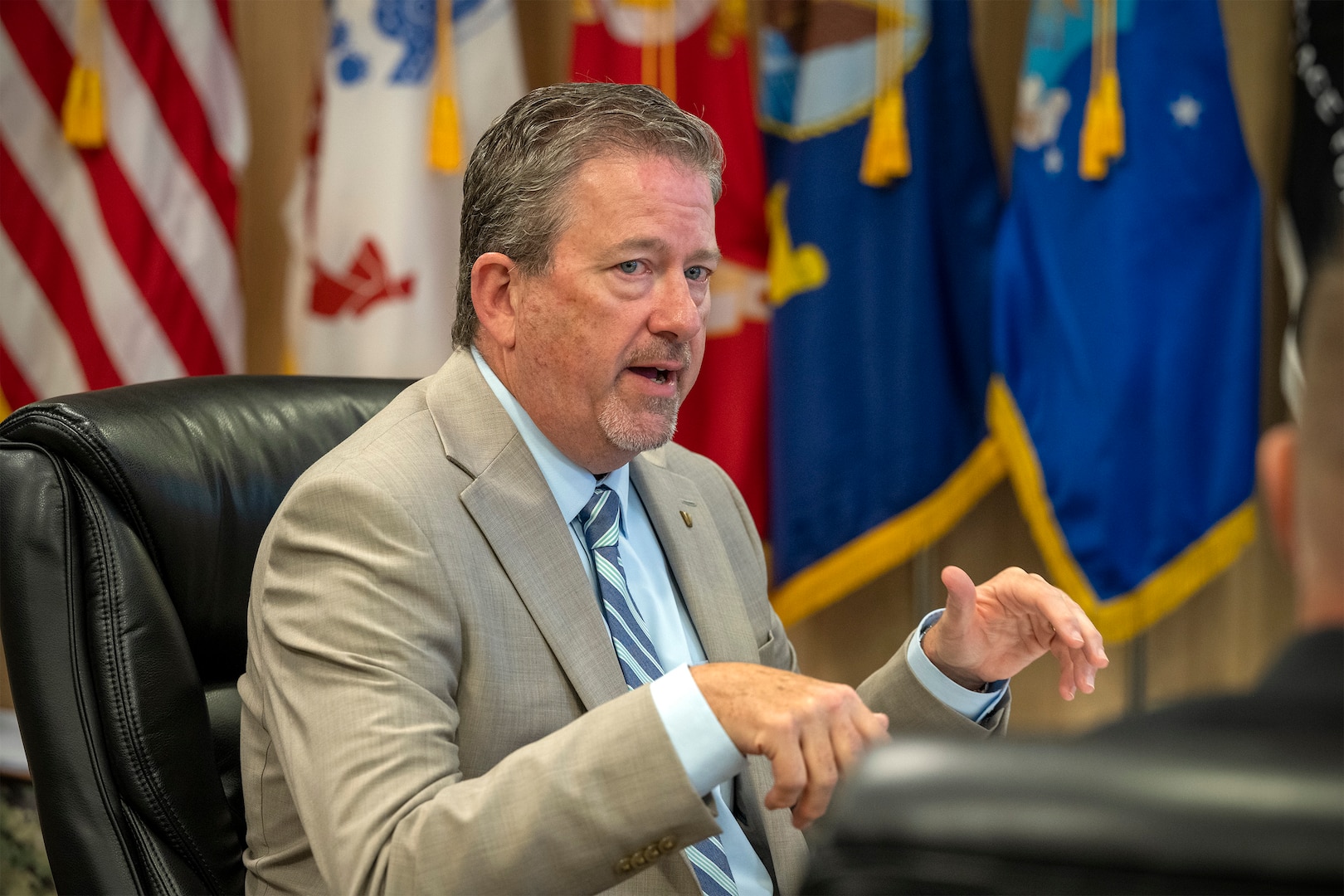 Defense Logistics Agency Vice Director Brad Bunn talks with DLA Disposition Services leaders at the Hart-Dole-Inouye Federal Center in Battle Creek, Michigan on August 11, 2026.