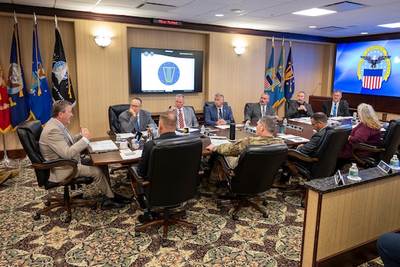 Defense Logistics Agency Vice Director Brad Bunn (far left) talks with DLA Disposition Services staff at the Hart-Dole-Inouye Federal Center in Battle Creek, Michigan on August 11, 2026.