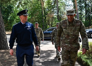 U.S. Air Force Gen. Dagvin Anderson, commander, U.S. Africa Command, left, and U.S. Air Force Col. Gabriel Brown, 406th Air Expeditionary Wing commander, right, walk into the 406th AEW headquarters building ahead of a wing visit at Ramstein Air Base, Germany, August 10, 2026. The 406th AEW provided Anderson an immersion and overview of their role as the only U.S. Air Force wing on the African continent and how they support combatant command objectives. (U.S. Air Force photo by Capt. Benjamin Aronson)
