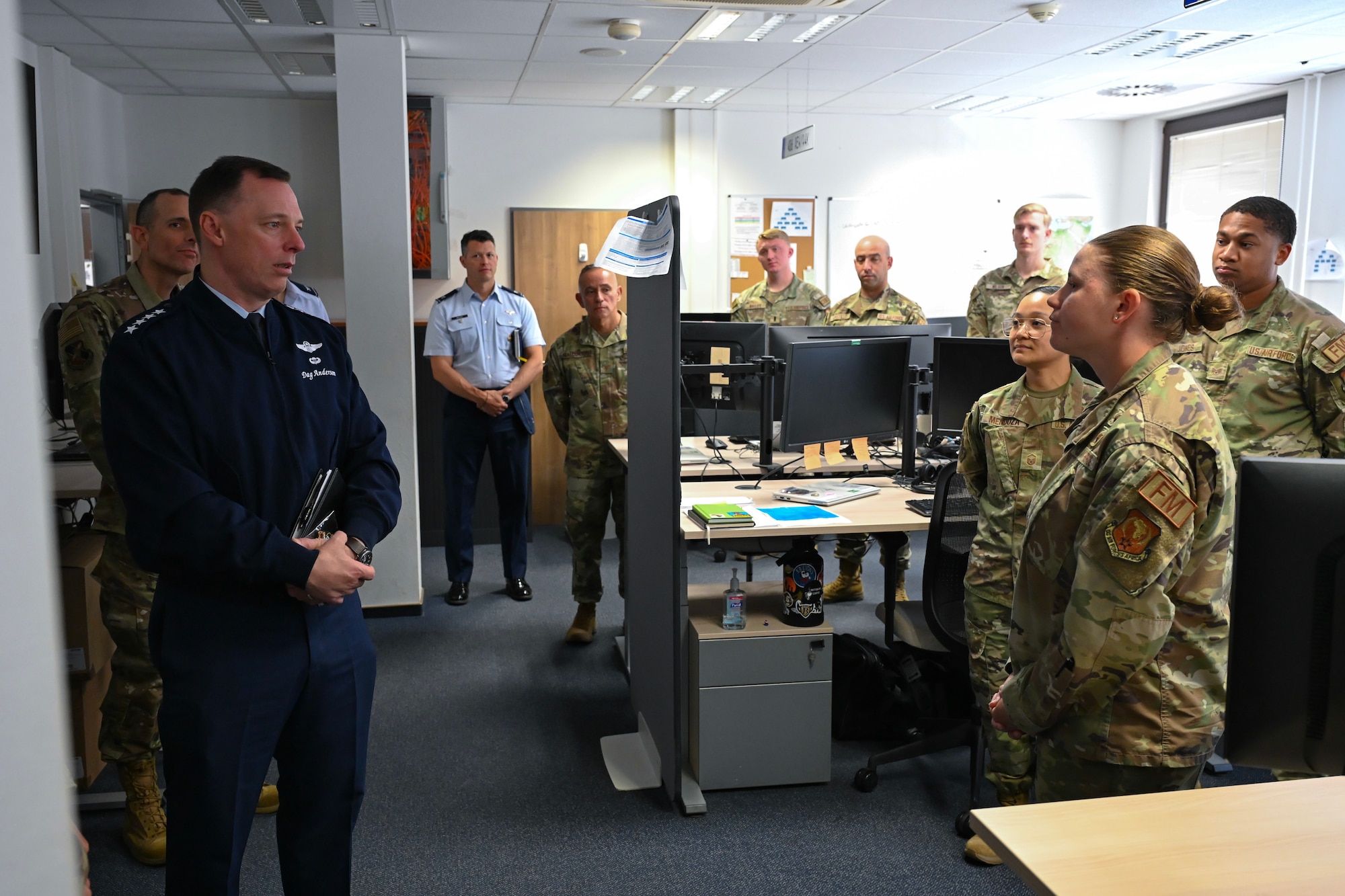 U.S. Air Force Gen. Dagvin Anderson, commander, U.S. Africa Command, left, speaks with U.S. Air Force 1st Lt. Christin Wintermantel, 406th Air Expeditionary Wing comptroller, during a wing immersion at Ramstein Air Base, Germany, August 10, 2026. The 406th AEW provided Anderson an immersion and overview of their role as the only U.S. Air Force wing on the African continent and how they support combatant command objectives. (U.S. Air Force photo by Capt. Benjamin Aronson)