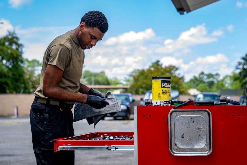 Airman gathering tools before working on vehicle