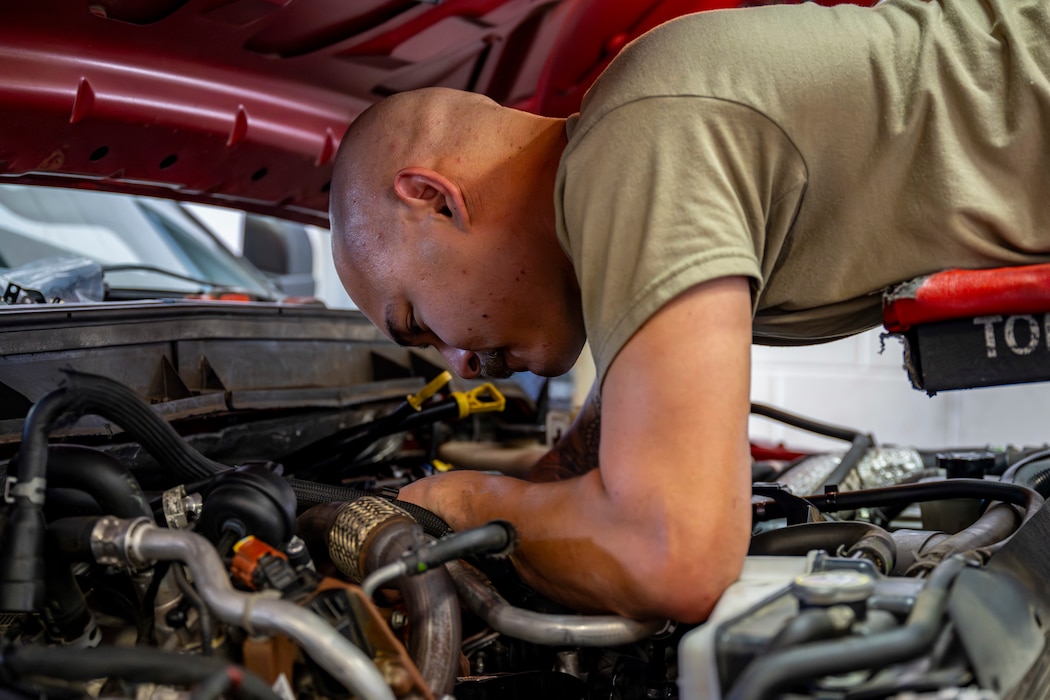 Vehicle Maintenance airman working on engine