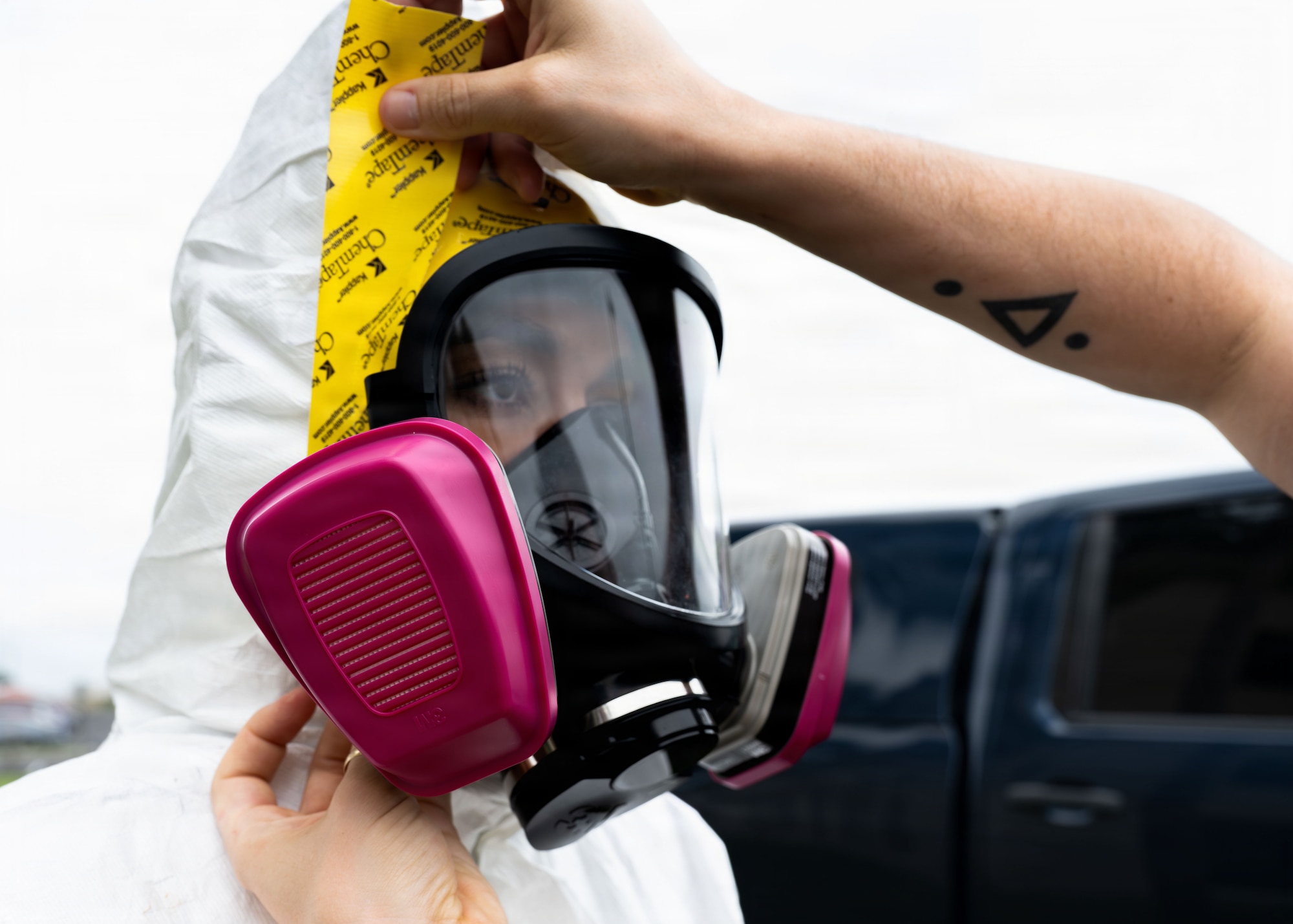 U.S. Air Force Airman 1st Class Emma Musser, 6th Operational Medical Readiness Squadron bioenvironmental engineering technician, donning a full level C hazmat suit at MacDill Air Force Base, Florida, July 30, 2026. The Bioenvironmental Engineering Flight monitors occupational exposures around X-ray equipment, evaluate laser hazards and advise incident commanders during emergency hazardous material responses, fuel spills and aircraft incidents. (U.S. Air Force photo by Senior Airman Nelvis Sera)