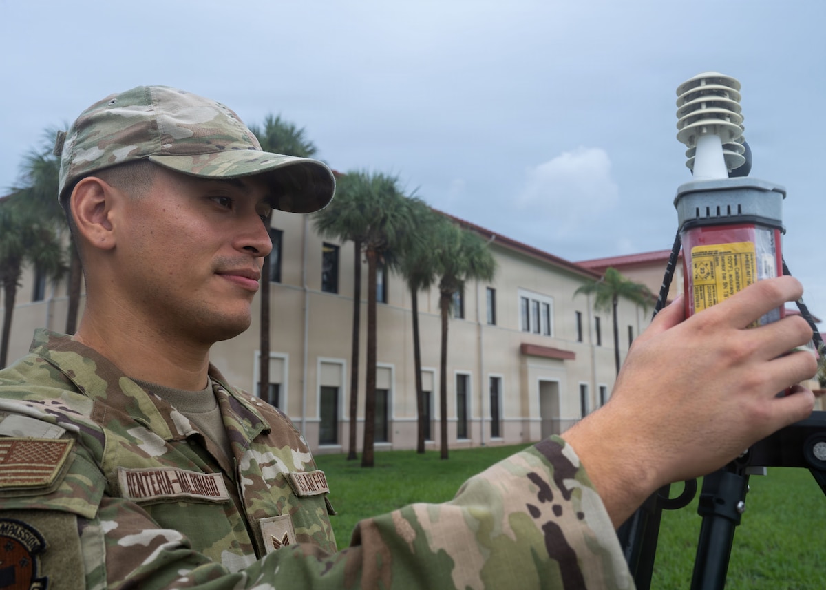 U.S. Air Force Senior Airman Kevin Renteria-Maldonada, 6th Operational Medical Readiness Squadron bioenvironmental engineering technician, records a wet bulb globe temperature reading at MacDill Air Force Base, Florida, Aug. 3, 2026. The Bioenvironmental Engineering Flight monitors WBGT conditions across the installation, issuing daily heat-flag notifications to help commanders implement work-rest cycles during Florida’s extreme summer temperatures. (U.S. Air Force photo by Senior Airman Nelvis Sera)