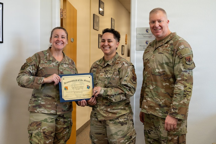 Col. Christine Littlejohn, Chief Master Sgt. Scott Castrovinci, and Tech. Sgt. Sarah Gonzales pose for a photo.