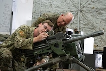 U.S. Air Force Gen. S.L. Davis, commander of Air Force Global Strike Command, receives a brief about the Mk 19 grenade launcher from Airman 1st Class Ayden Kozlowsky, a 91st Missile Security Operations Squadron member, at Minot Air Force Base, North Dakota, July 30, 2026.