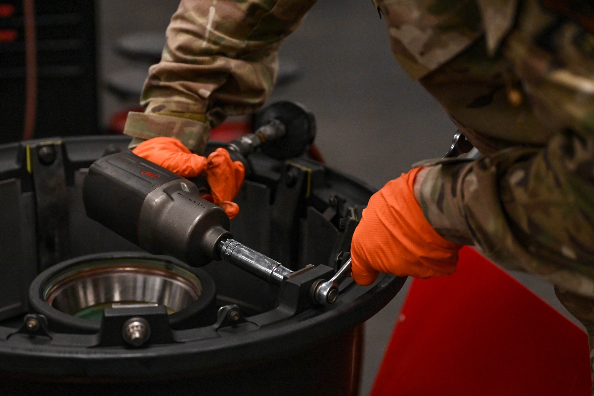 Col. Mark Hamilton, 1st Special Operations Wing commander, installs a heat shield inside an aircraft wheel during a leadership immersion at Hurlburt Field, Florida, July 24, 2026.