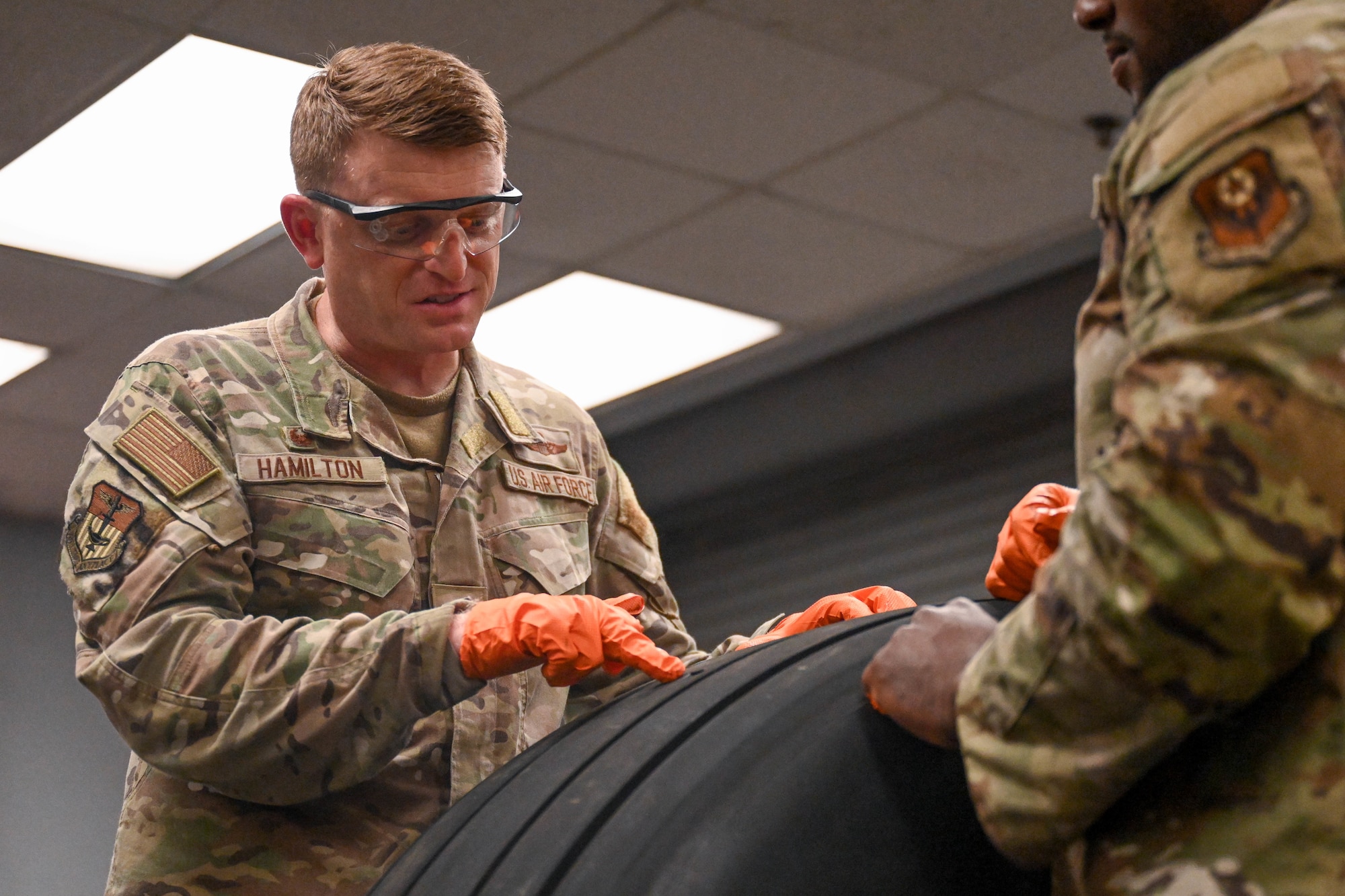 Chief Master Sgt. Joshua Moore, 1st Special Operations Wing command chief, left, and Col. Mark Hamilton, 1st SOW commander, don protective gear during a leadership immersion at Hurlburt Field, Florida, July 24, 2026.