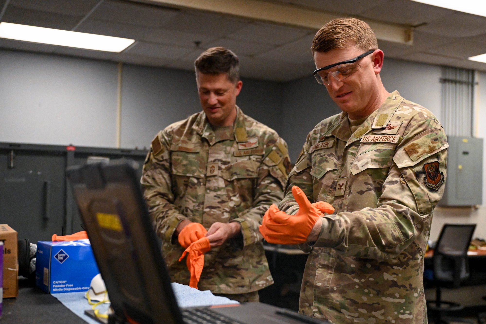 Chief Master Sgt. Joshua Moore, 1st Special Operations Wing command chief, left, and Col. Mark Hamilton, 1st SOW commander, don protective gear during a leadership immersion at Hurlburt Field, Florida, July 24, 2026.