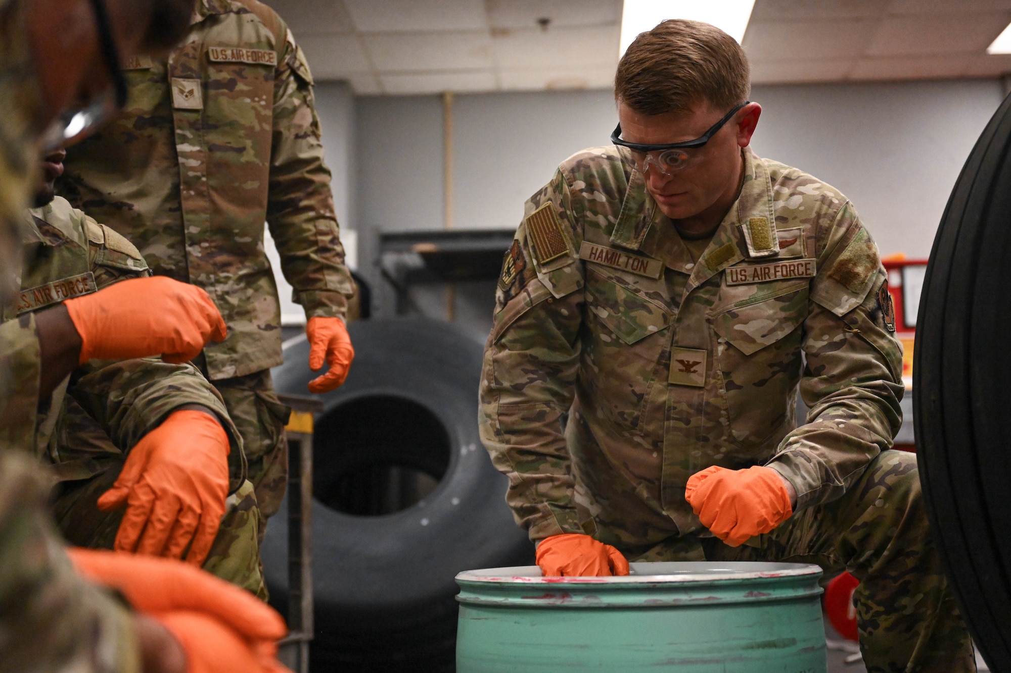 Col. Mark Hamilton, 1st Special Operations Wing commander, applies lubricant to an aircraft wheel during a leadership immersion at Hurlburt Field, Florida, July 24, 2026.