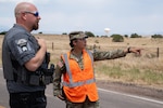 U.S. Army Sgt. Lyric Nieto-Fernandez, 220th Military Police Company, Colorado Army National Guard speaks with an officer from the Fremont County Sheriff’s Office while managing traffic control points for road closures and evacuated areas near the Aspen Acres Fire, Pueblo, Colorado, July 9, 2026. More than 80 service members were activated after Colorado Governor Jared Polis declared a state of emergency and authorized the Colorado National Guard to mobilize in support of the fire response. At the time, the Aspen Acres Fire was the largest wildfire in the state, having burnt more than 100,000 acres. (U.S. Army National Guard photo by Staff Sgt. Josiah Pugh)