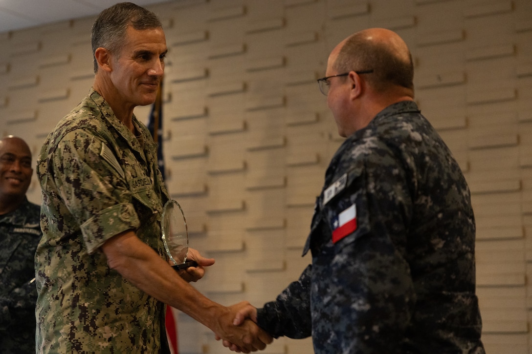 Rear Adm. Carlos Sardiello, commander, U.S. Naval Forces Southern Command/U.S. 4th Fleet, gives Chilean Navy Capt. Juan Pablo Villanueva an award at the final ceremony of exercise Panamax 2026. PANAMAX is a U.S. Southern Command-sponsored exercise focused on strengthening hemispheric command and control and enhancing regional cooperation to secure the Western Hemisphere. (U.S. Navy photo by Mass Communication Specialist Third Class David Keenan)