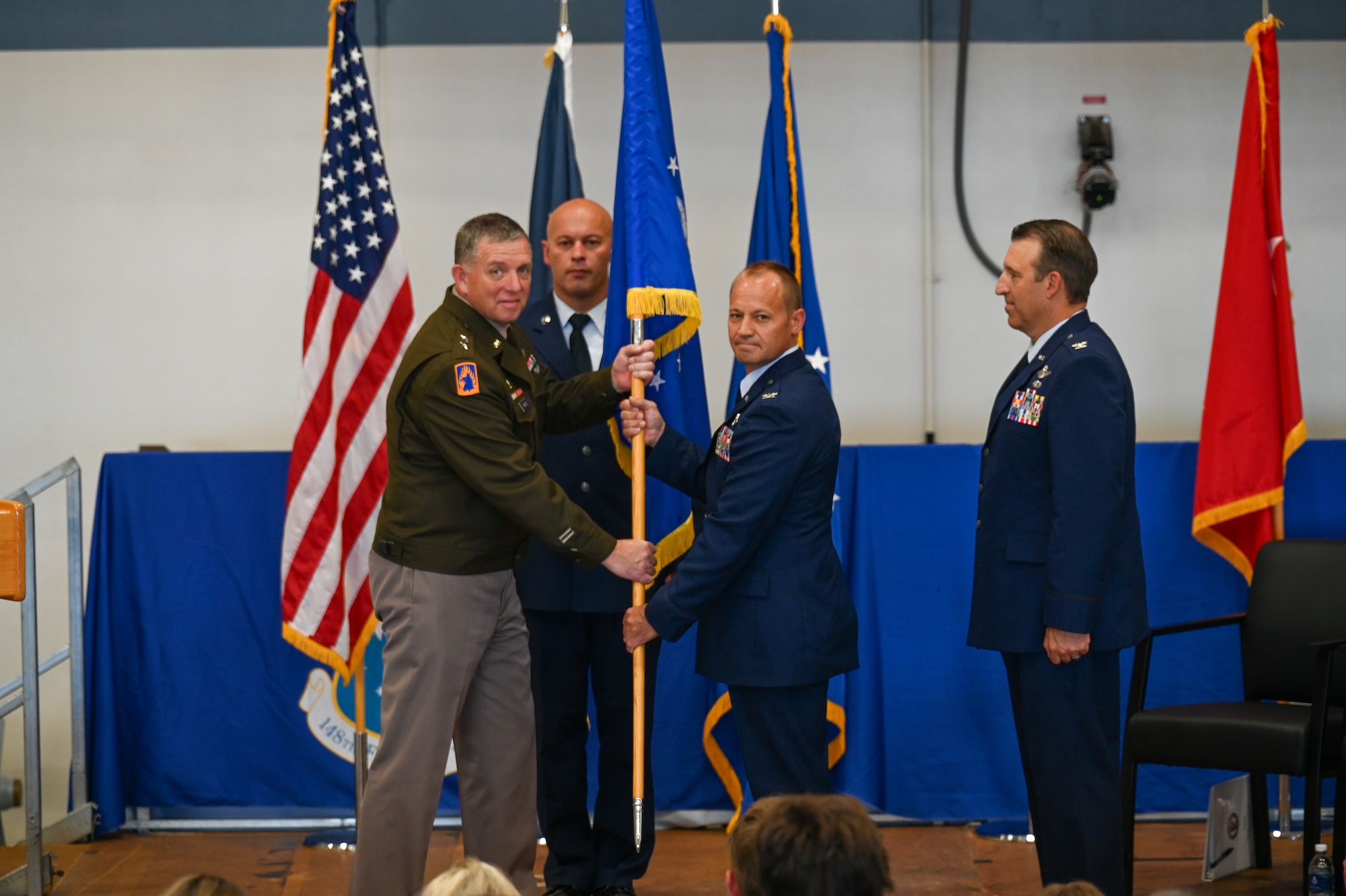 U.S. Air Force Col. Curt Grayson, incoming 148th Fighter Wing commander, receives the 148th Fighter Wing guidon from U.S. Army Maj. Gen. Shawn Manke, adjutant general, Minnesota National Guard, at the 148th Fighter Wing, Duluth, Minnesota, Aug. 1, 2026. The ceremony marked the transition of leadership from Aysta to Grayson, as he assumed command of mission-ready Airmen who are dedicated to countering present and future threats. (U.S. Air National Guard photo by Staff Sgt. Tylin Rust)