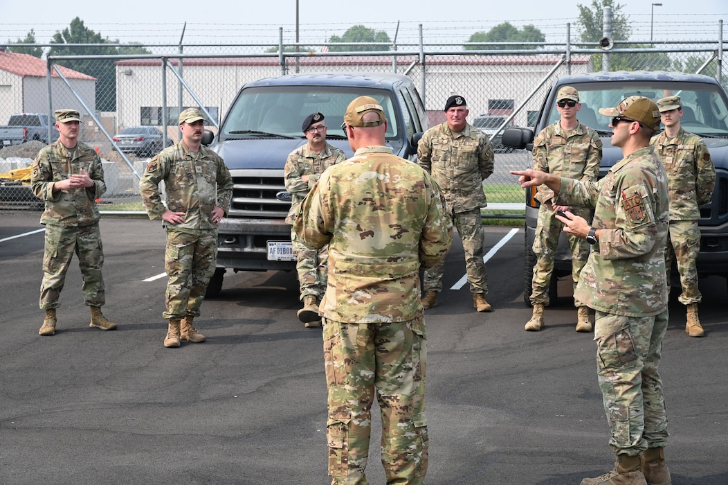 uniformed members stand and hear a briefing