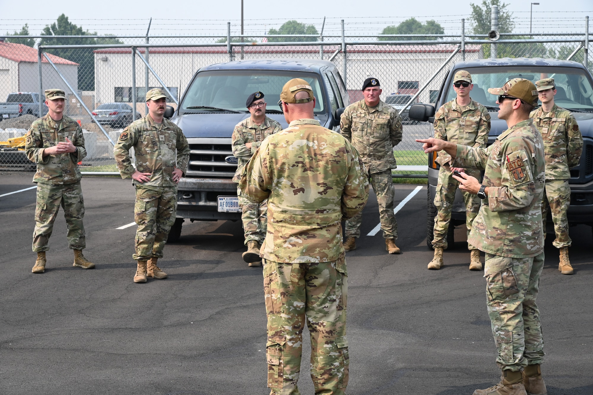 uniformed members stand and hear a briefing