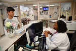 A medical support assistant in Kenner Army Health Clinic's Wilkerson Pediatric Clinic, checks the credentials of a dependent prior to an appointment. Medical and dental treatment for warfighters and dependents are an important part of military compensation.