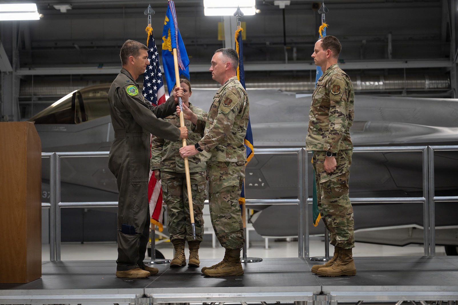 A photo of U.S. Air Force Chief Master Sgt Jeffrey Steadman, the outgoing command chief of the 158th Fighter Wing, presenting the guidon to Col. Michael Blair, the commander of the 158th Fighter Wing, during a change of responsibility ceremony at the Vermont Air National Guard Base, South Burlington, Vermont.