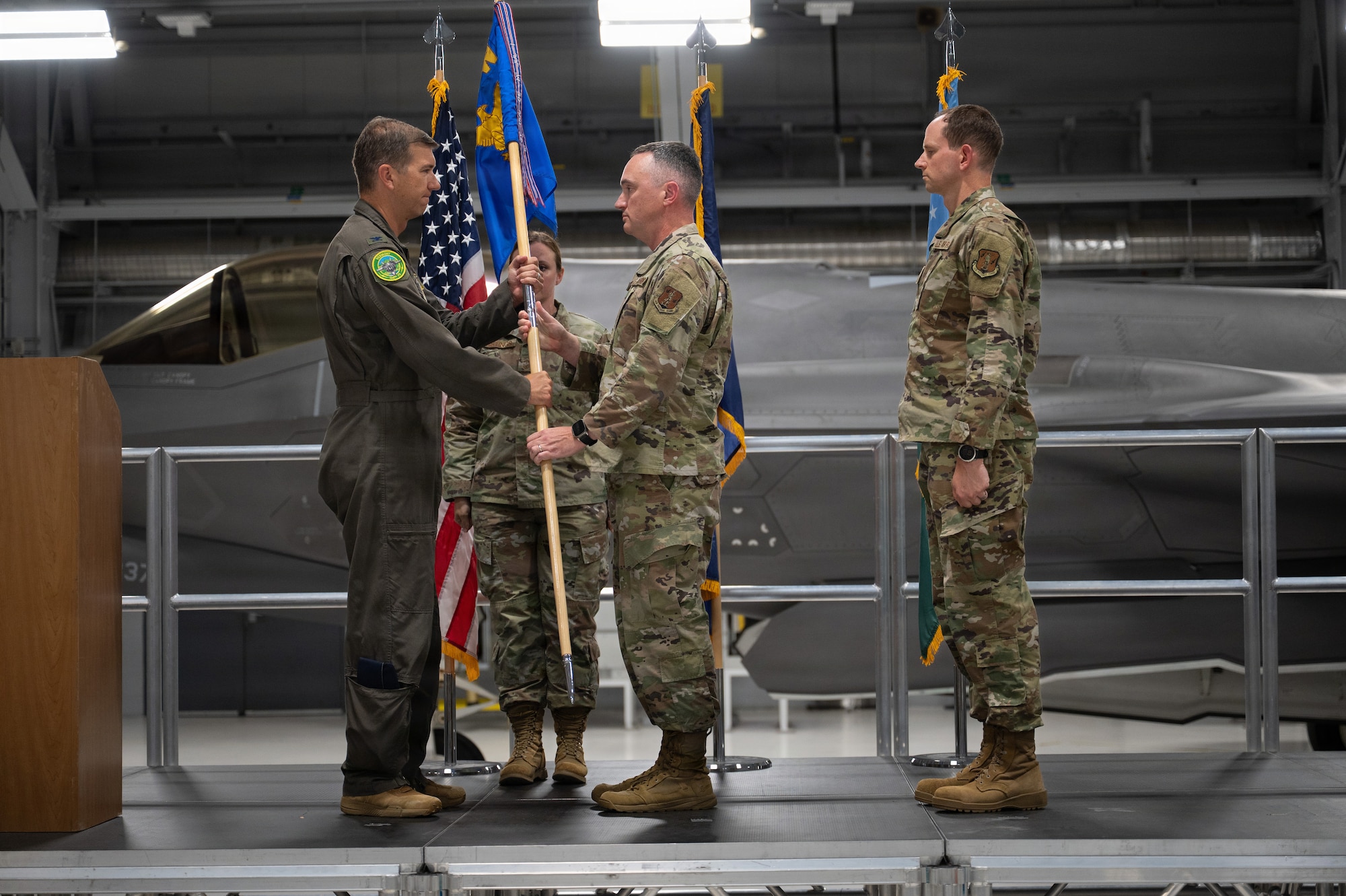 A photo of U.S. Air Force Chief Master Sgt Jeffrey Steadman, the outgoing command chief of the 158th Fighter Wing, presenting the guidon to Col. Michael Blair, the commander of the 158th Fighter Wing, during a change of responsibility ceremony at the Vermont Air National Guard Base, South Burlington, Vermont.