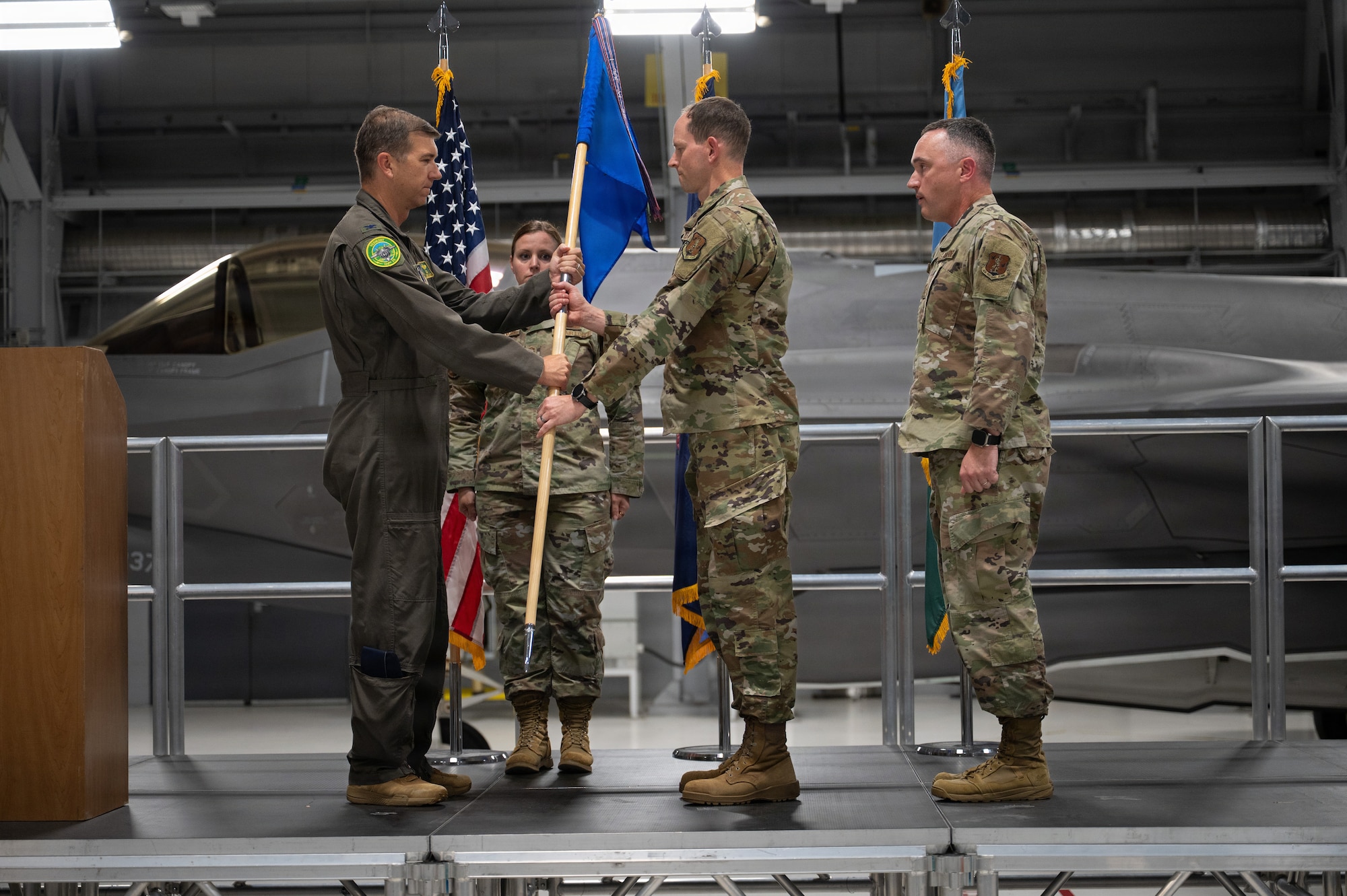 A photo of U.S. Air Force Col. Michael Blair, the commander of the 158th Fighter Wing, presenting the guidon to Chief Master Sgt. Daniel Dickerson, the incoming command chief of the 158th Fighter Wing, during a change of responsibility ceremony at the Vermont Air National Guard Base, South Burlington, Vermont.