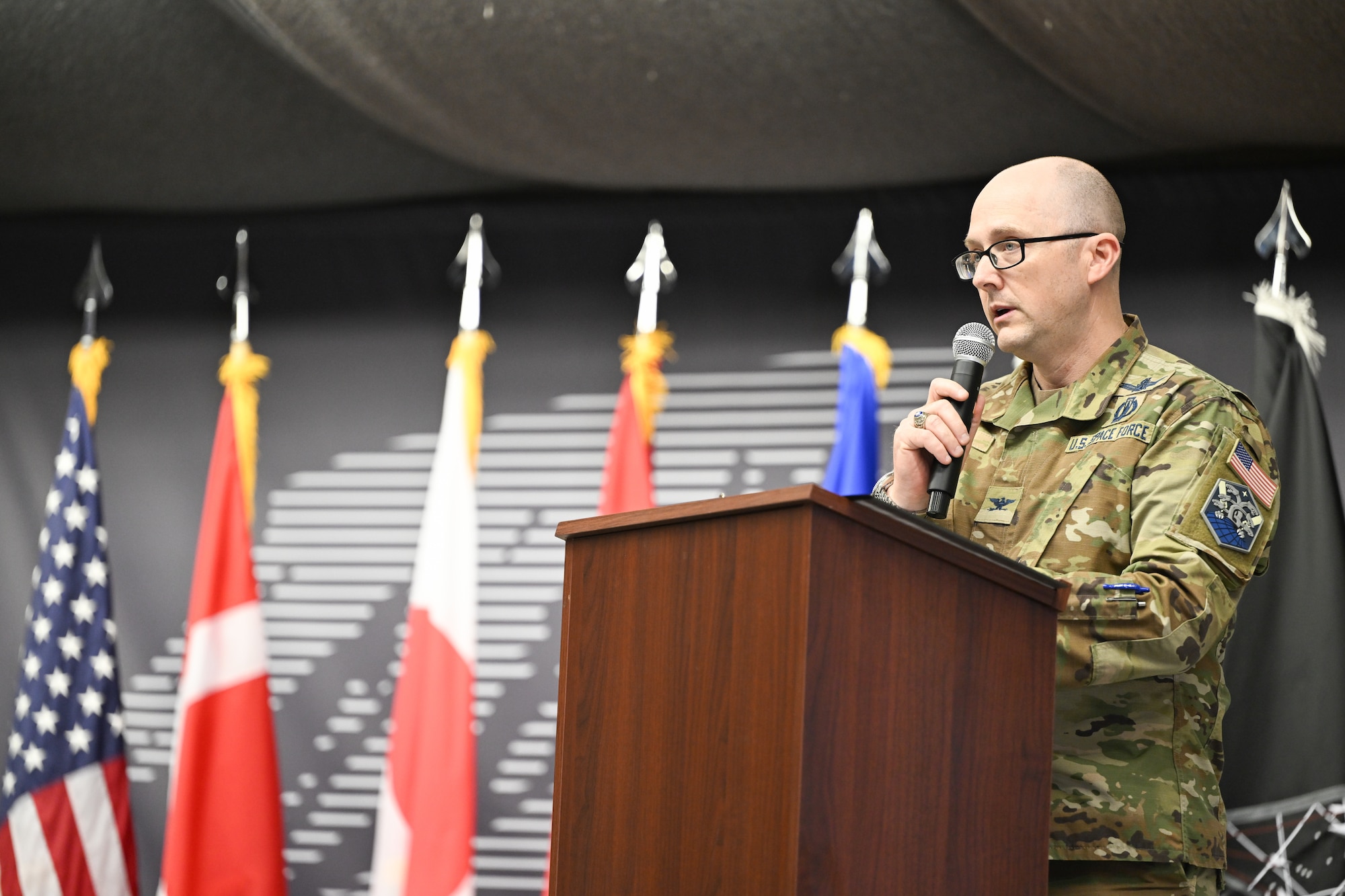 Military member gives a speech on stage.