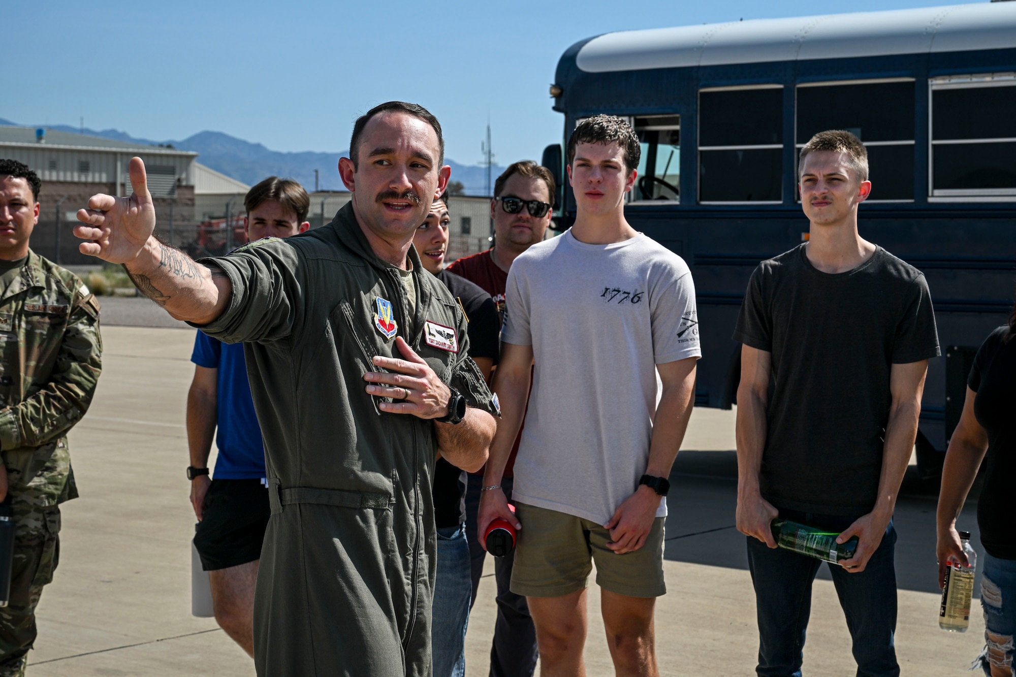 U.S. Airmen and Air Force Delayed Entry Program recruits pose for a group photo during a base tour at Davis-Monthan Air Force Base, Arizona, Aug. 7, 2026. Hosted by local recruiters, the event offered participants a firsthand look at the missions and people that support the 355th Wing. (U.S. Air Force photo by Airman 1st Class Samantha Melecio)