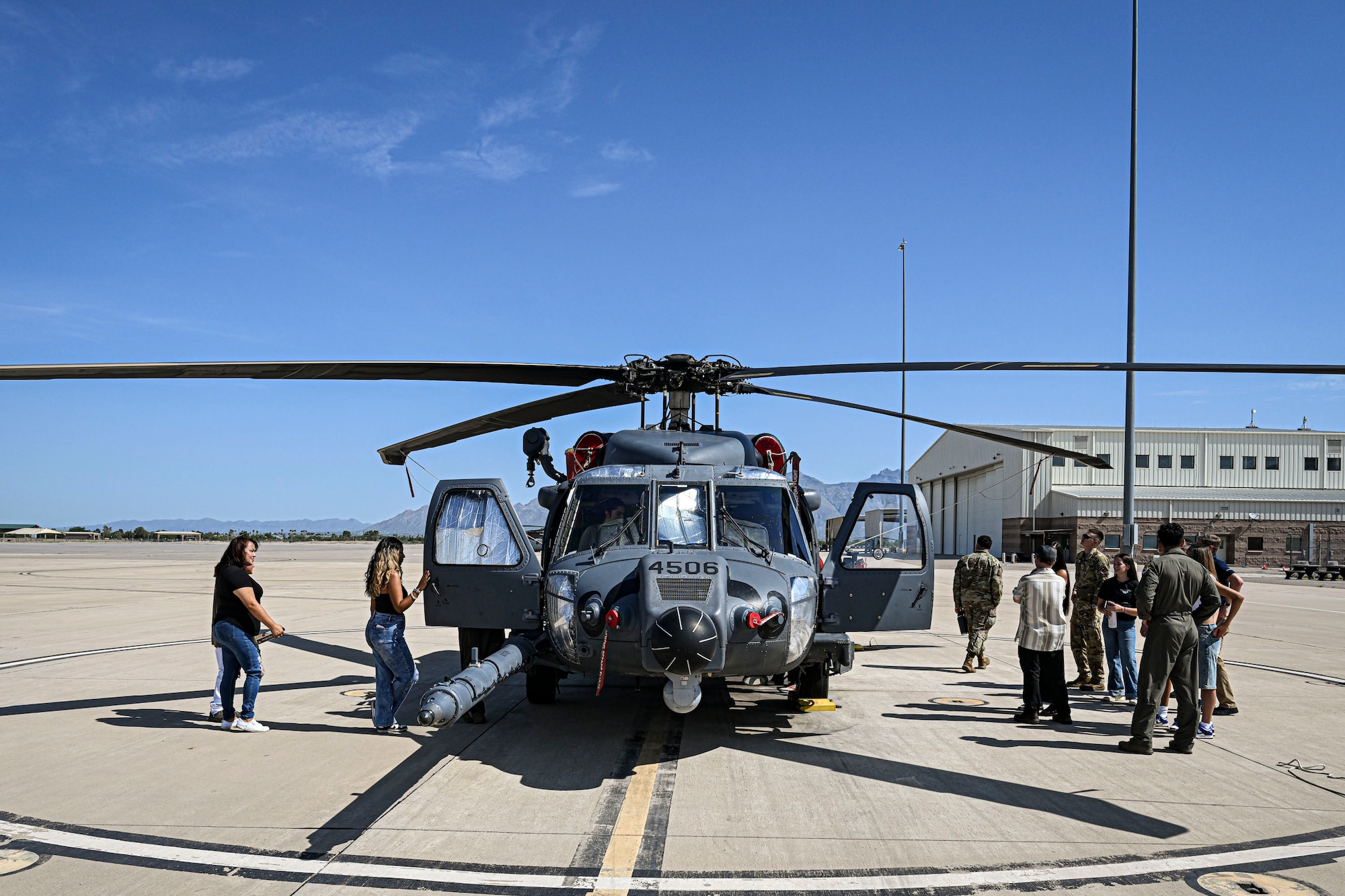 U.S. Airmen and Air Force Delayed Entry Program recruits pose for a group photo during a base tour at Davis-Monthan Air Force Base, Arizona, Aug. 7, 2026. Hosted by local recruiters, the event offered participants a firsthand look at the missions and people that support the 355th Wing. (U.S. Air Force photo by Airman 1st Class Samantha Melecio)