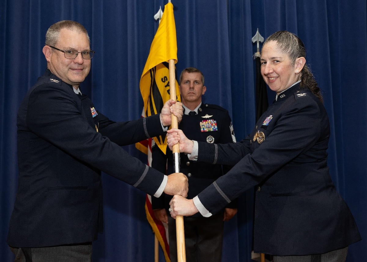 COLORADO SPRINGS, Colo. – USSF Col. Richard Beckman, portfolio acquisition executive for infrastructure, (left) presents the System Delta 81 guidon to USSF Col. Margaret “Maggie” Sullivan, incoming commander of Space Systems Command (SSC) System Delta 81, during a change of command ceremony at Peterson Space Force Base, Aug. 6. System Delta 81 works in conjunction with Space Training and Readiness Command (STARCOM) to plan, execute, and deliver essential systems underpinning Space Force test, training, and tactics development. The transfer of the guidon symbolizes the formal assumption of command. (Photo by USAF Staff Sgt. Ryan Quijas)