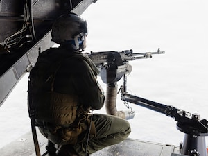 U.S. Marine Corps Gunnery Sgt. Hawken Helmandollar, an MV-22B Osprey aircrew chief assigned to Marine Medium Tiltrotor Squadron (VMM) 164 (Reinforced), 15th Marine Expeditionary Unit, fires an M240B medium machine gun in a U.S. Marine Corps MV-22B Osprey attached to VMM-164 (Rein.), 15th MEU, during a live-fire exercise in the Pacific Ocean, Aug. 10, 2026.