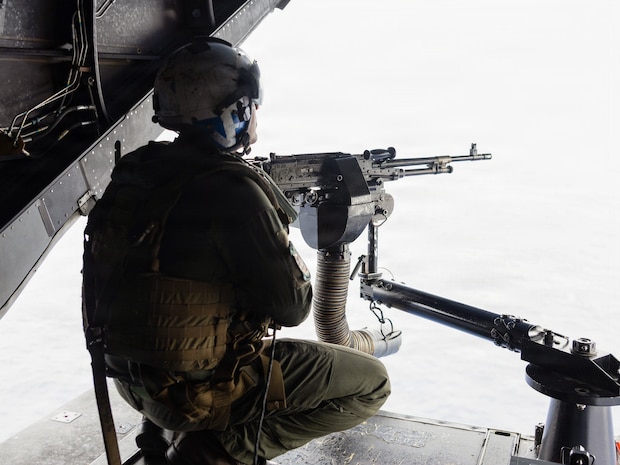 U.S. Marine Corps Gunnery Sgt. Hawken Helmandollar, an MV-22B Osprey aircrew chief assigned to Marine Medium Tiltrotor Squadron (VMM) 164 (Reinforced), 15th Marine Expeditionary Unit, fires an M240B medium machine gun in a U.S. Marine Corps MV-22B Osprey attached to VMM-164 (Rein.), 15th MEU, during a live-fire exercise in the Pacific Ocean, Aug. 10, 2026.