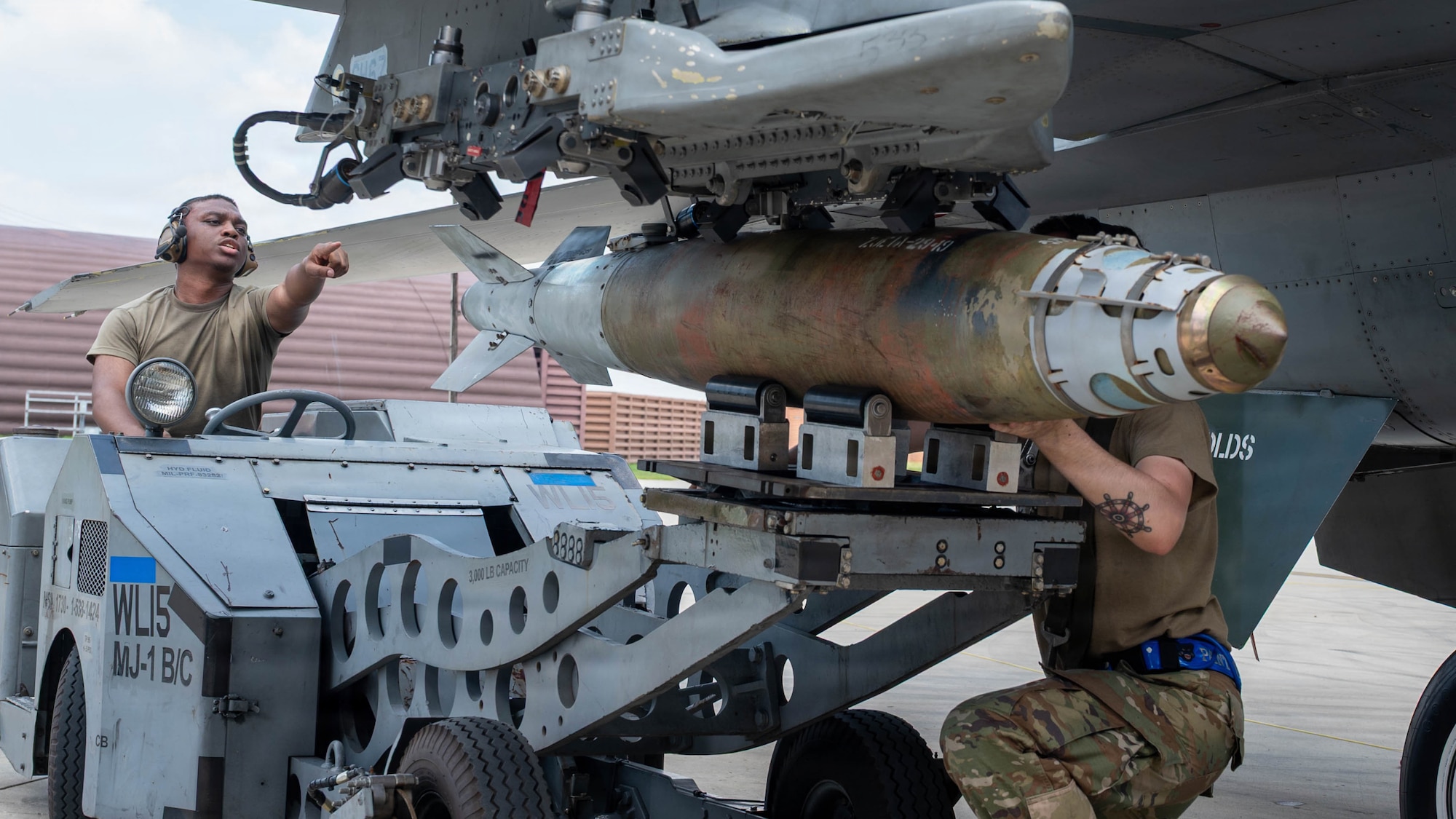 U.S. Air Force Staff Sgt. Kevin Jones, left, and Staff Sgt. Thomas Clark, assigned to the 51st Maintenance Group, transports a GBU-38 during the second-quarter Ammo Bomb Building and Loading Competition at Osan Air Base, Republic of Korea, Aug. 6, 2026. The competition prepared Airmen to execute Osan’s “Fight Tonight” mission anytime, anywhere. (U.S. Air Force photo by Senior Airman Jessica Mun)