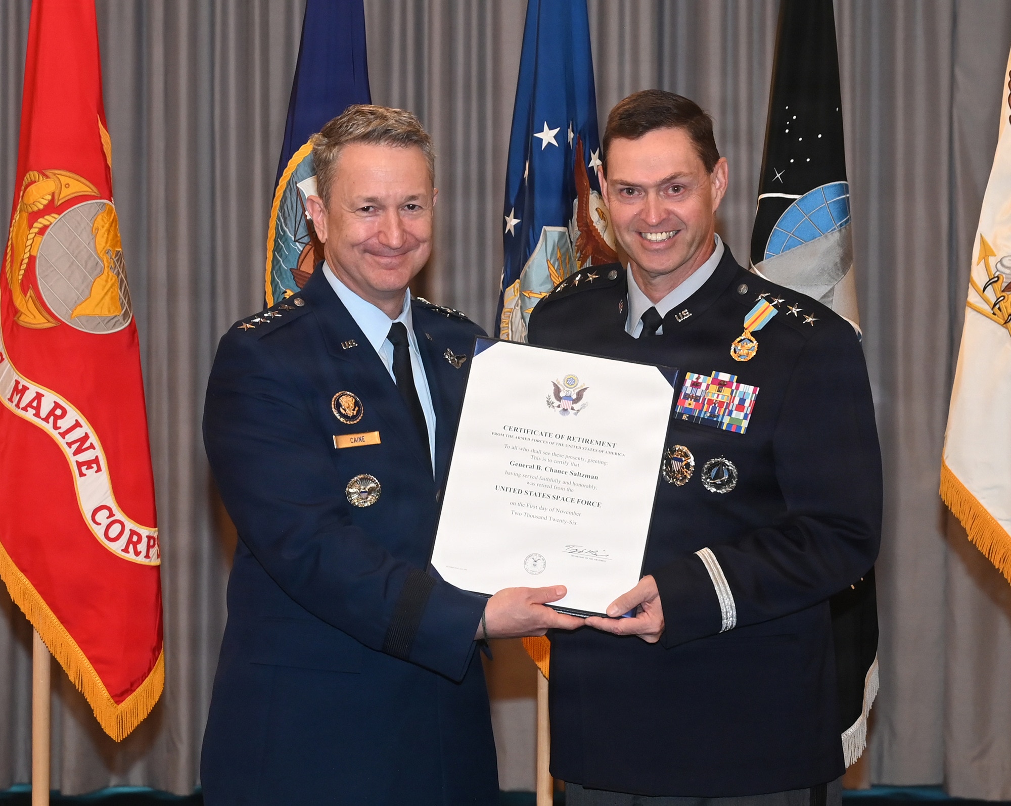 Chairman of the Joint Chiefs of Staff Gen. Dan Caine presents a retirement certificate to Chief of Space Operations Gen. Chance Saltzman during his retirement ceremony, Joint Base Anacostia-Bolling, Washington D.C., Aug. 13, 2026. Saltzman was the second Chief of Space Operations and originally commissioned into the Air Force in 1991. (U.S. Air Force photo by Andy Morataya)