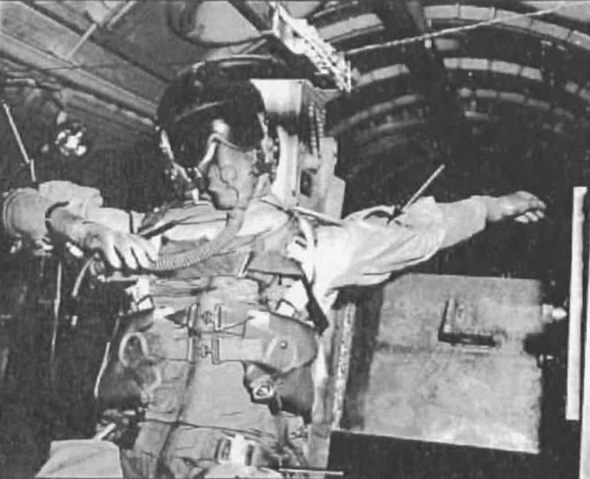 The damage done to a dummy following wind blast testing in the T-2 test cell of the Arnold Engineering Development Center Engine Test Facility is highlighted is this photo from a 1957 technical report. Arrows show where the arms of the dummy bent during testing. This testing, conducted in June 1957, assessed the impact of dynamic pressure on several configurations of flight gear. (U.S. Air Force image)