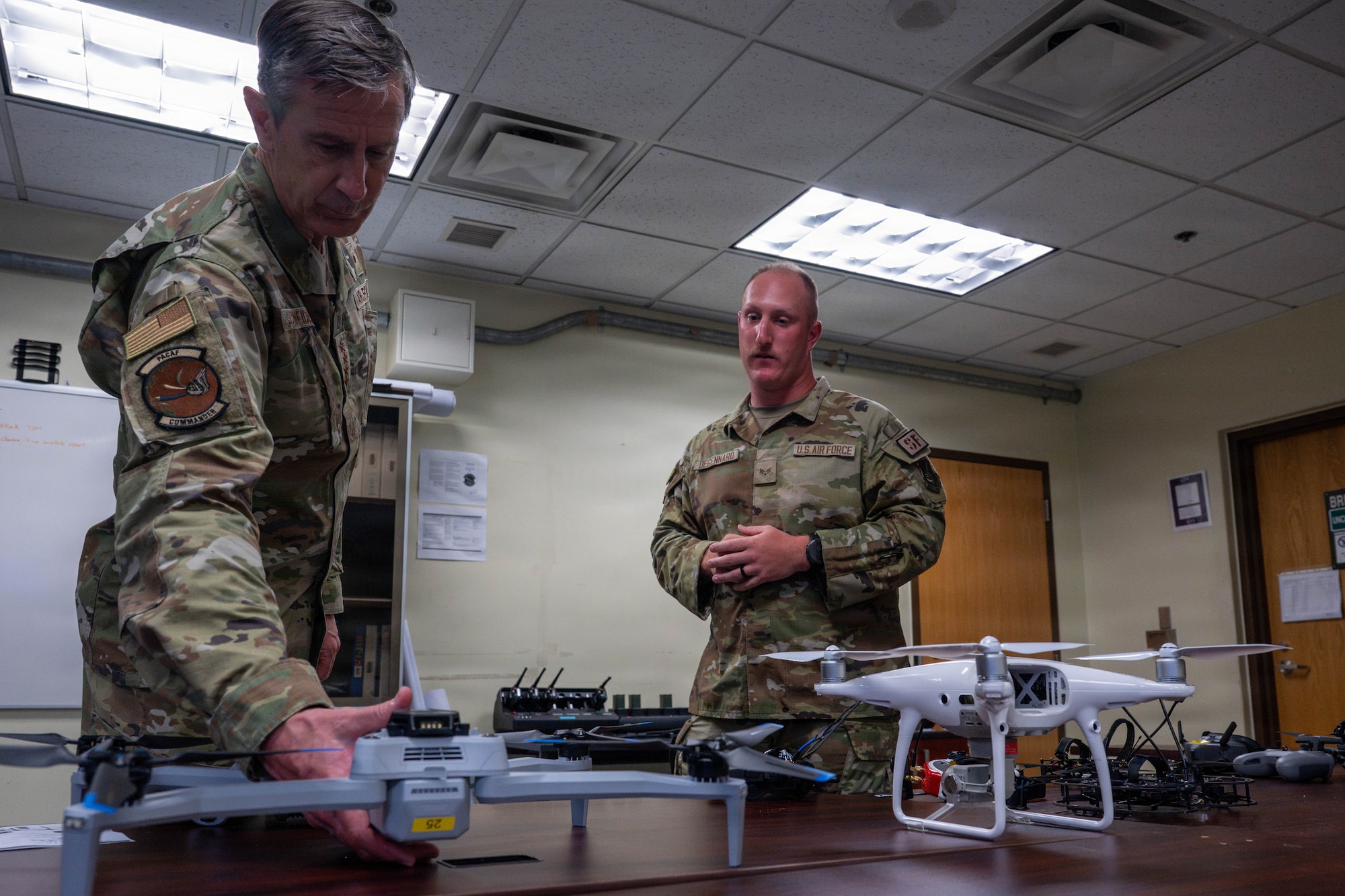 Gen. Schneider picks up drone.